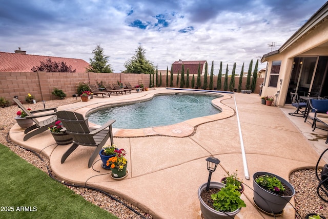 view of swimming pool with a patio, a fenced in pool, and a fenced backyard