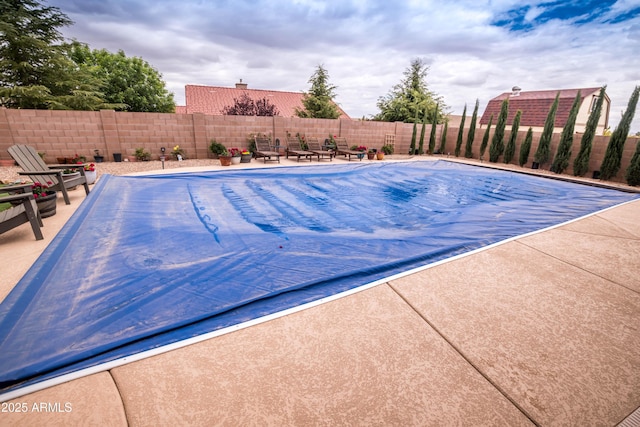 view of pool featuring a patio area, a fenced in pool, and a fenced backyard
