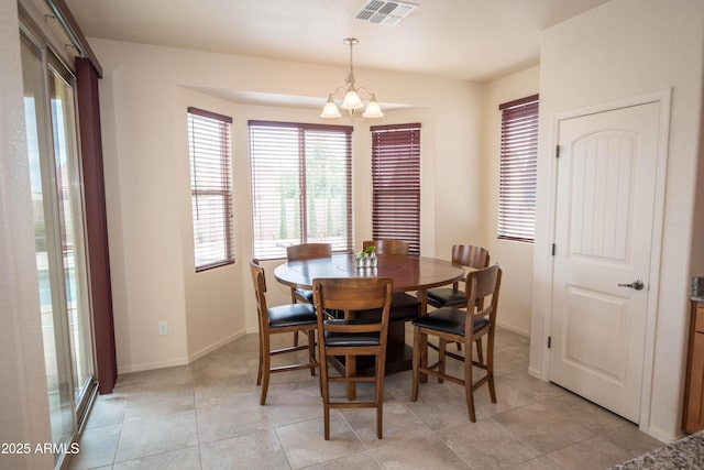 dining room featuring a chandelier, visible vents, baseboards, and light tile patterned flooring