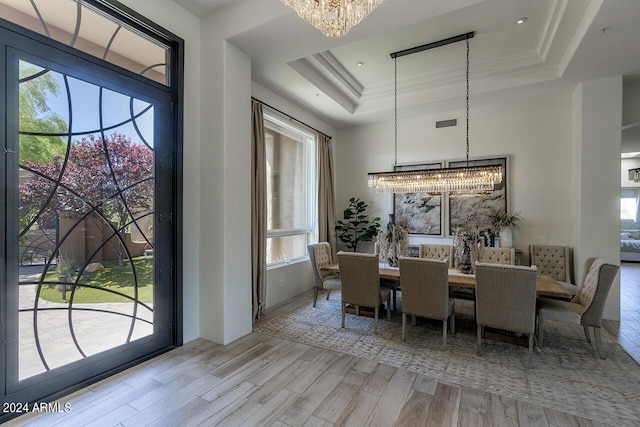 30600 N Pima Rd Unit 49, Scottsdale, AZ 85266 - dining room featuring visible vents, wood finished floors, an inviting chandelier, a raised ceiling, and a towering ceiling