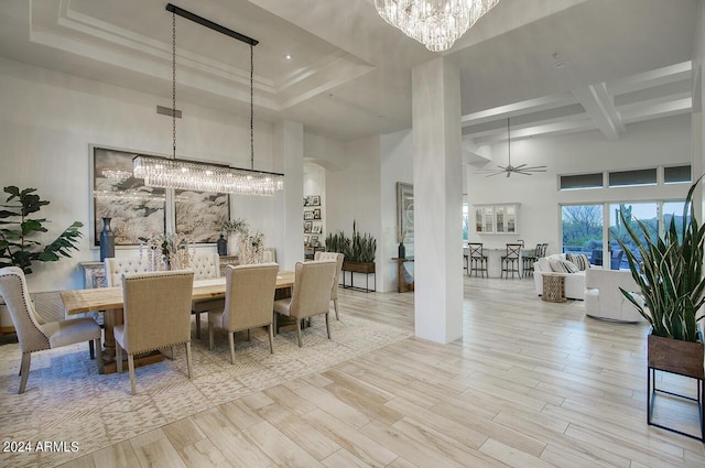 30600 N Pima Rd Unit 49, Scottsdale, AZ 85266 - dining room featuring a tray ceiling, beam ceiling, ceiling fan with notable chandelier, a towering ceiling, and wood finished floors