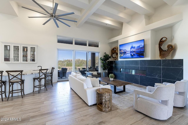 30600 N Pima Rd Unit 49, Scottsdale, AZ 85266 - living area with beamed ceiling, a fireplace, light wood-type flooring, and a towering ceiling