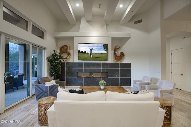 30600 N Pima Rd Unit 49, Scottsdale, AZ 85266 - living room featuring a towering ceiling, visible vents, wood finished floors, and a fireplace