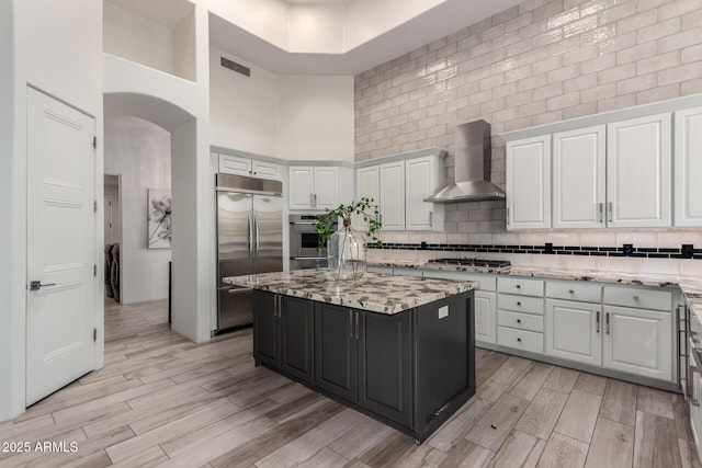 30600 N Pima Rd Unit 49, Scottsdale, AZ 85266 - kitchen with white cabinetry, wall chimney range hood, visible vents, and appliances with stainless steel finishes