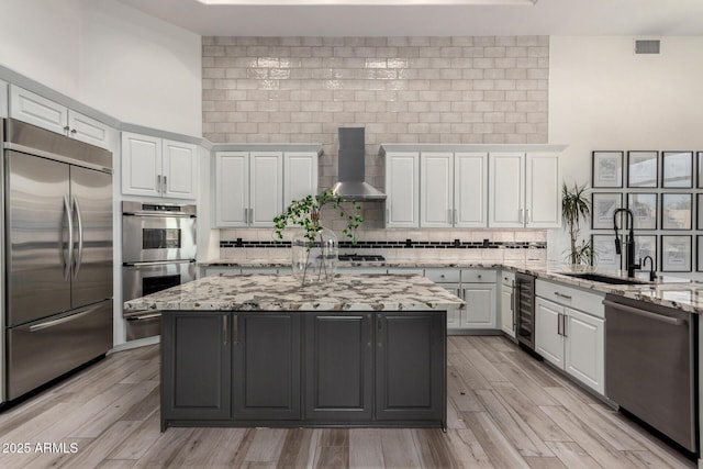 30600 N Pima Rd Unit 49, Scottsdale, AZ 85266 - kitchen featuring tasteful backsplash, beverage cooler, appliances with stainless steel finishes, wall chimney exhaust hood, and a sink