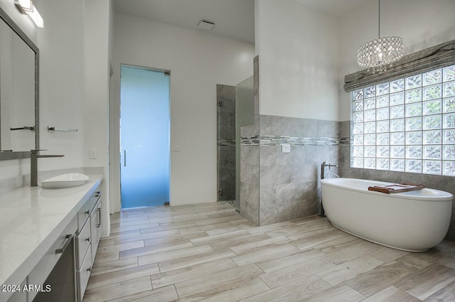 30600 N Pima Rd Unit 49, Scottsdale, AZ 85266 - bathroom with a soaking tub, tile walls, vanity, and a tile shower