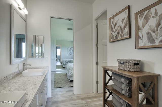 30600 N Pima Rd Unit 49, Scottsdale, AZ 85266 - bathroom featuring visible vents, ensuite bathroom, a sink, wood finished floors, and double vanity