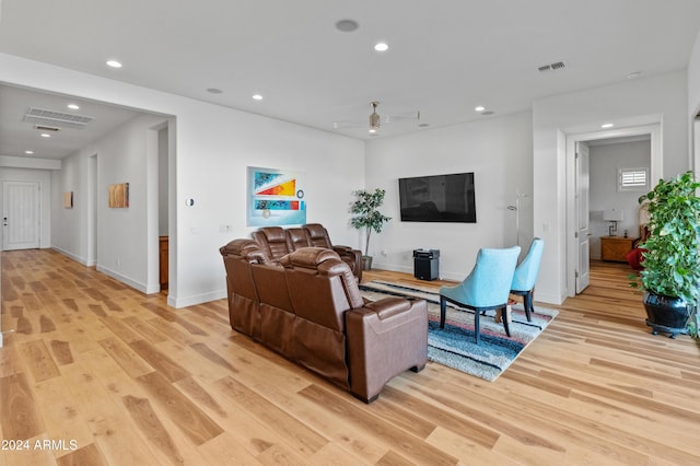 living room featuring ceiling fan and light wood-type flooring