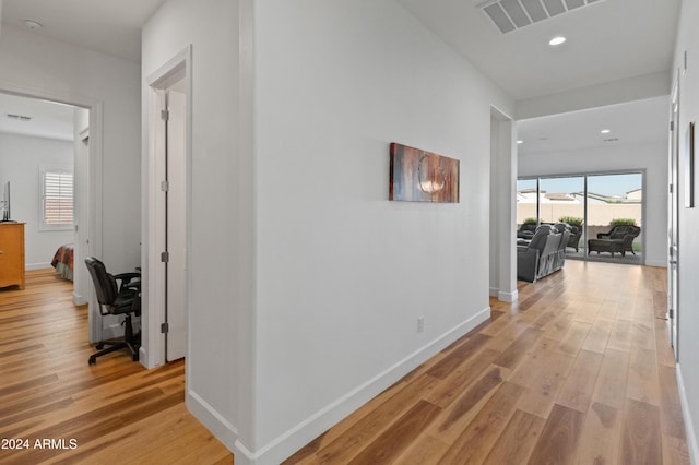 hallway with light hardwood / wood-style flooring