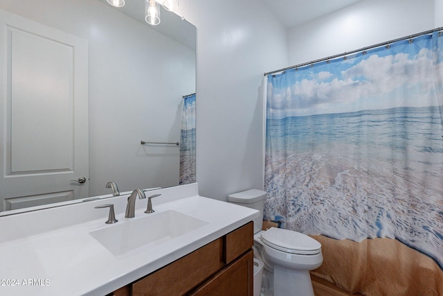 bathroom with vanity, toilet, and curtained shower