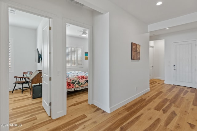 hall with hardwood / wood-style floors