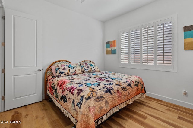 bedroom with hardwood / wood-style flooring