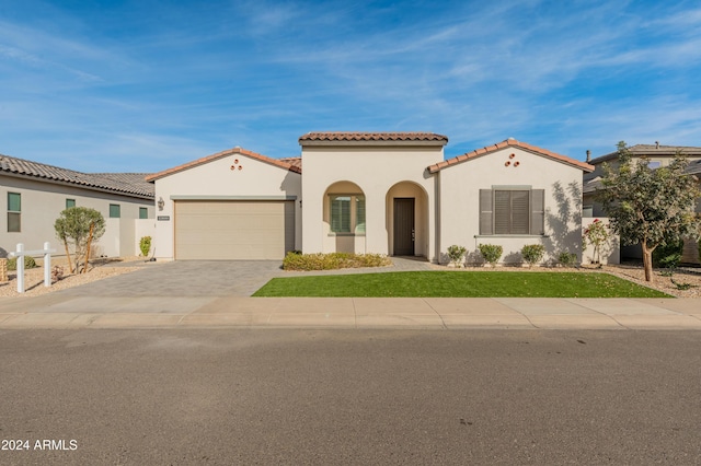 mediterranean / spanish home with a garage