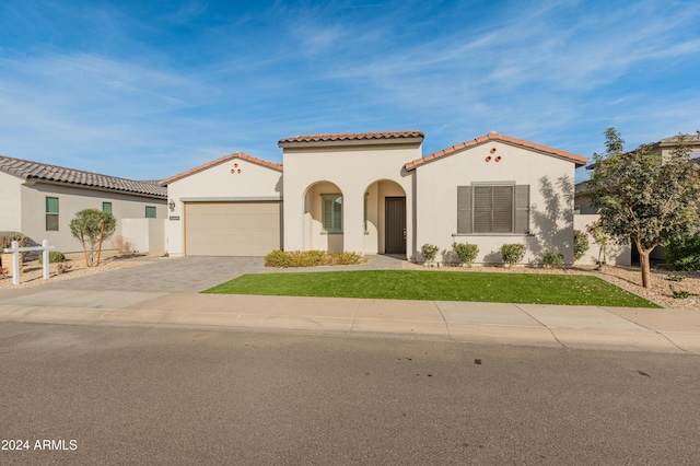 mediterranean / spanish-style house featuring a garage