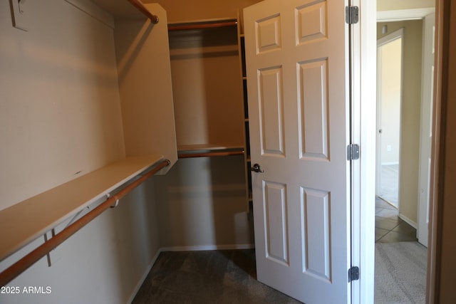 walk in closet with tile patterned floors