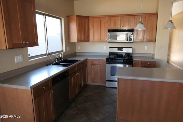 kitchen featuring appliances with stainless steel finishes, hanging light fixtures, and sink