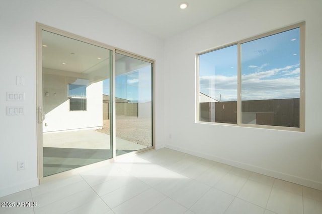 unfurnished room with recessed lighting and baseboards