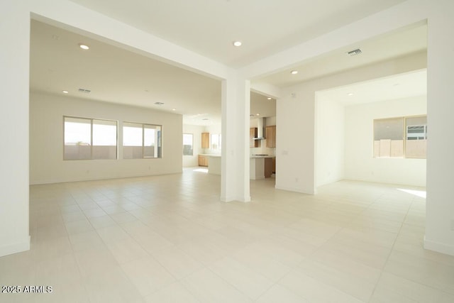 unfurnished room featuring recessed lighting, visible vents, and baseboards