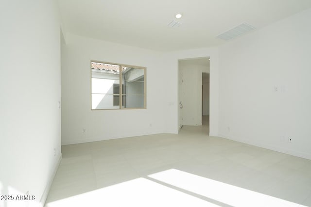 empty room featuring visible vents and baseboards