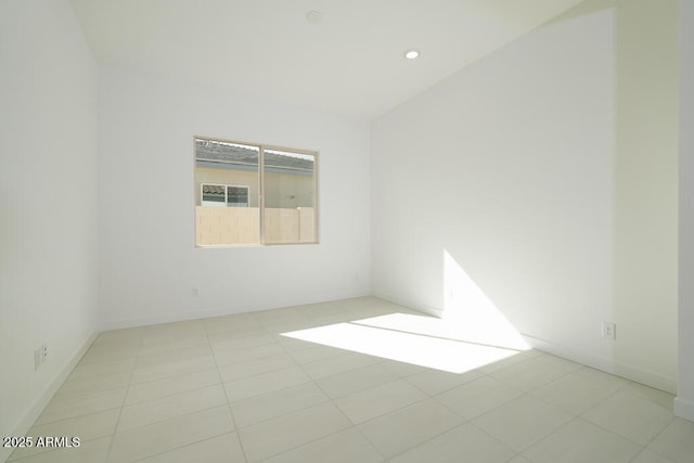 tiled spare room with recessed lighting