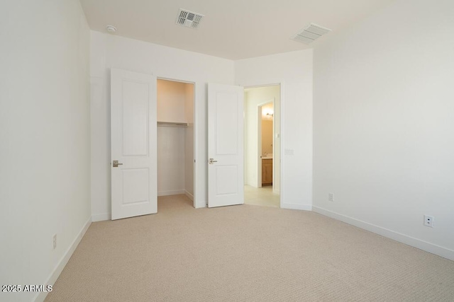 unfurnished bedroom featuring visible vents, baseboards, and light colored carpet