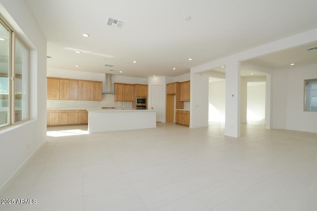 unfurnished living room featuring recessed lighting and visible vents