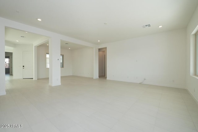 unfurnished room featuring recessed lighting, visible vents, and baseboards