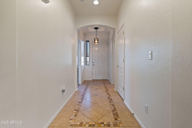 hall featuring tile patterned flooring