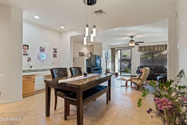 dining space with ceiling fan and light tile patterned flooring