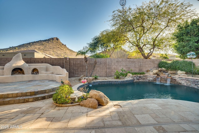 view of swimming pool with a patio area and pool water feature