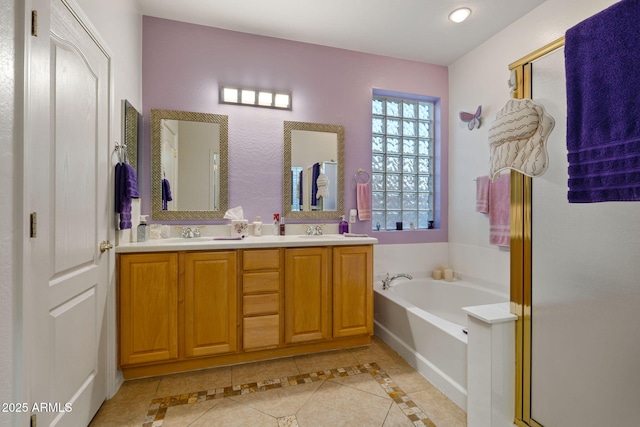 bathroom featuring independent shower and bath, tile patterned flooring, and vanity