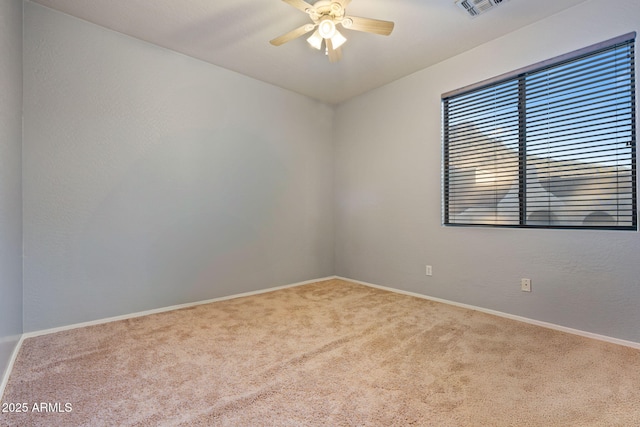 empty room with ceiling fan and carpet flooring