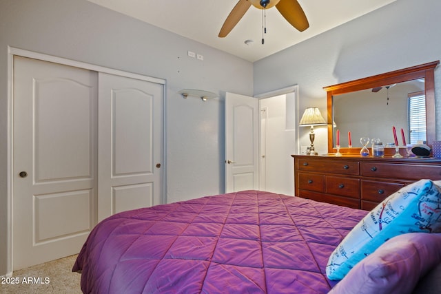 bedroom with light colored carpet, a closet, and ceiling fan