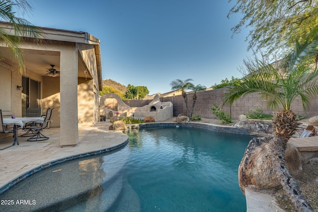 view of swimming pool featuring ceiling fan, pool water feature, and a patio