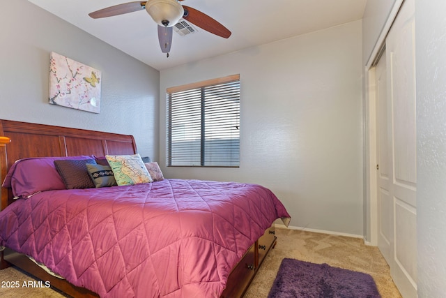 carpeted bedroom with a closet and ceiling fan