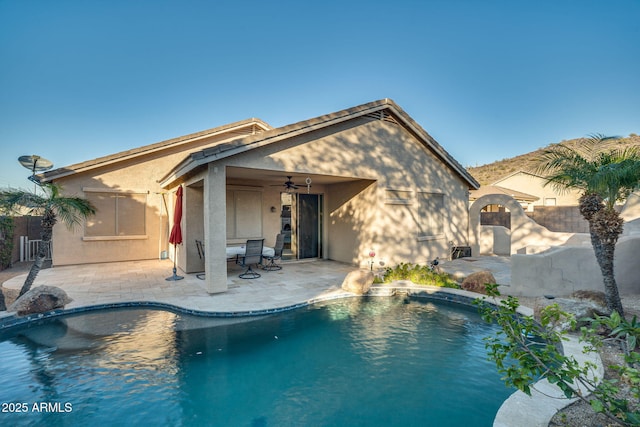 view of pool featuring ceiling fan and a patio area