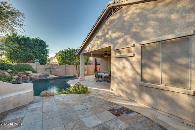 view of pool with ceiling fan and a patio