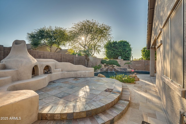 view of patio / terrace with an outdoor fireplace