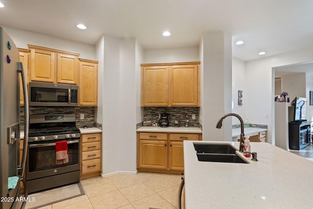 kitchen featuring sink, light brown cabinetry, appliances with stainless steel finishes, and decorative backsplash