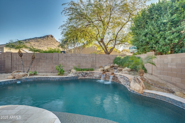 view of pool with a mountain view and pool water feature