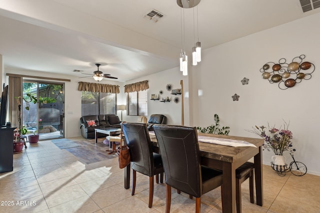 tiled dining space with plenty of natural light and ceiling fan