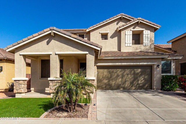 view of front facade with a garage, a tiled roof, concrete driveway, and stucco siding