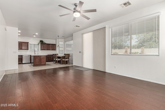 unfurnished living room featuring recessed lighting, visible vents, ceiling fan, a sink, and wood finished floors