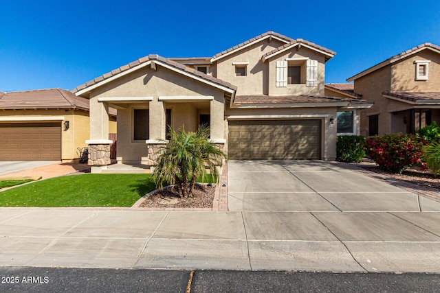 view of front of home with concrete driveway, a tiled roof, an attached garage, and stucco siding