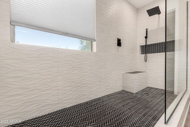 bathroom with a tile shower