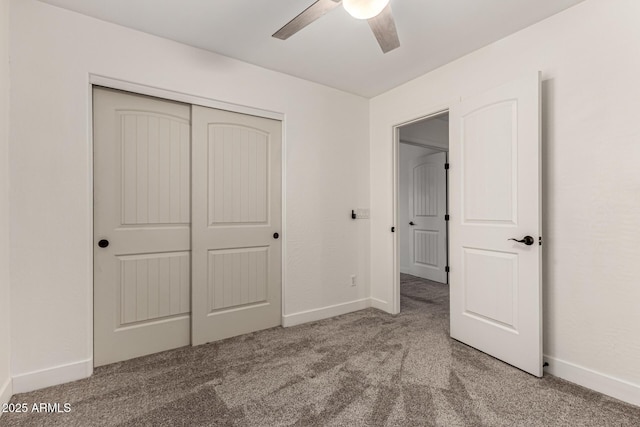 unfurnished bedroom with carpet floors, a closet, a ceiling fan, and baseboards