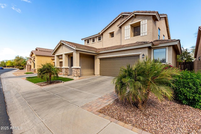 view of front of home featuring a garage, a tile roof, fence, driveway, and stucco siding