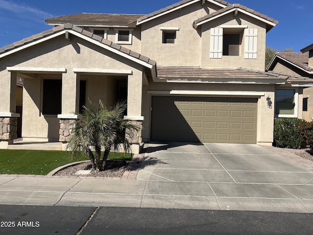 view of front of home with a garage, a tile roof, driveway, and stucco siding