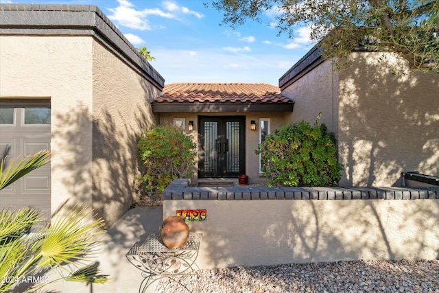 view of exterior entry featuring a garage