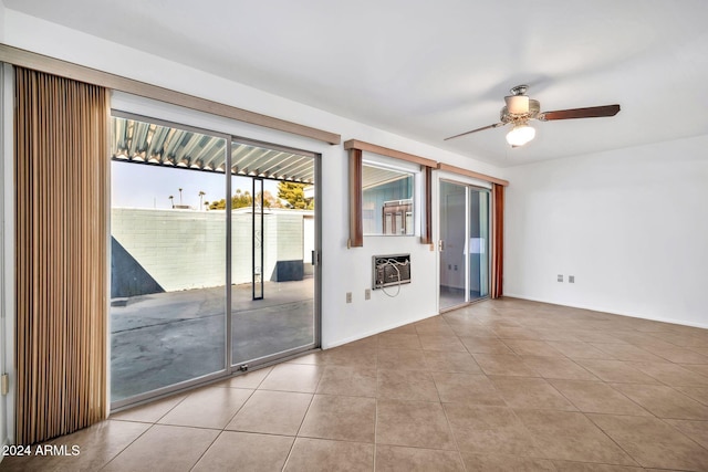 tiled empty room featuring ceiling fan